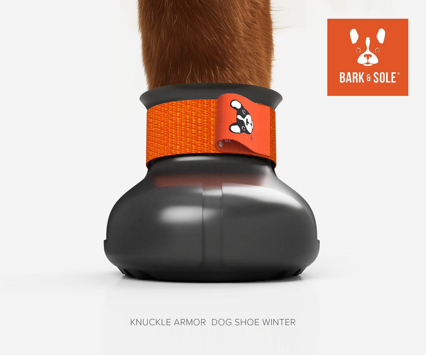 Winter dog shoe with knuckle armor and orange band on a white background, featuring the Bark & Sole logo.