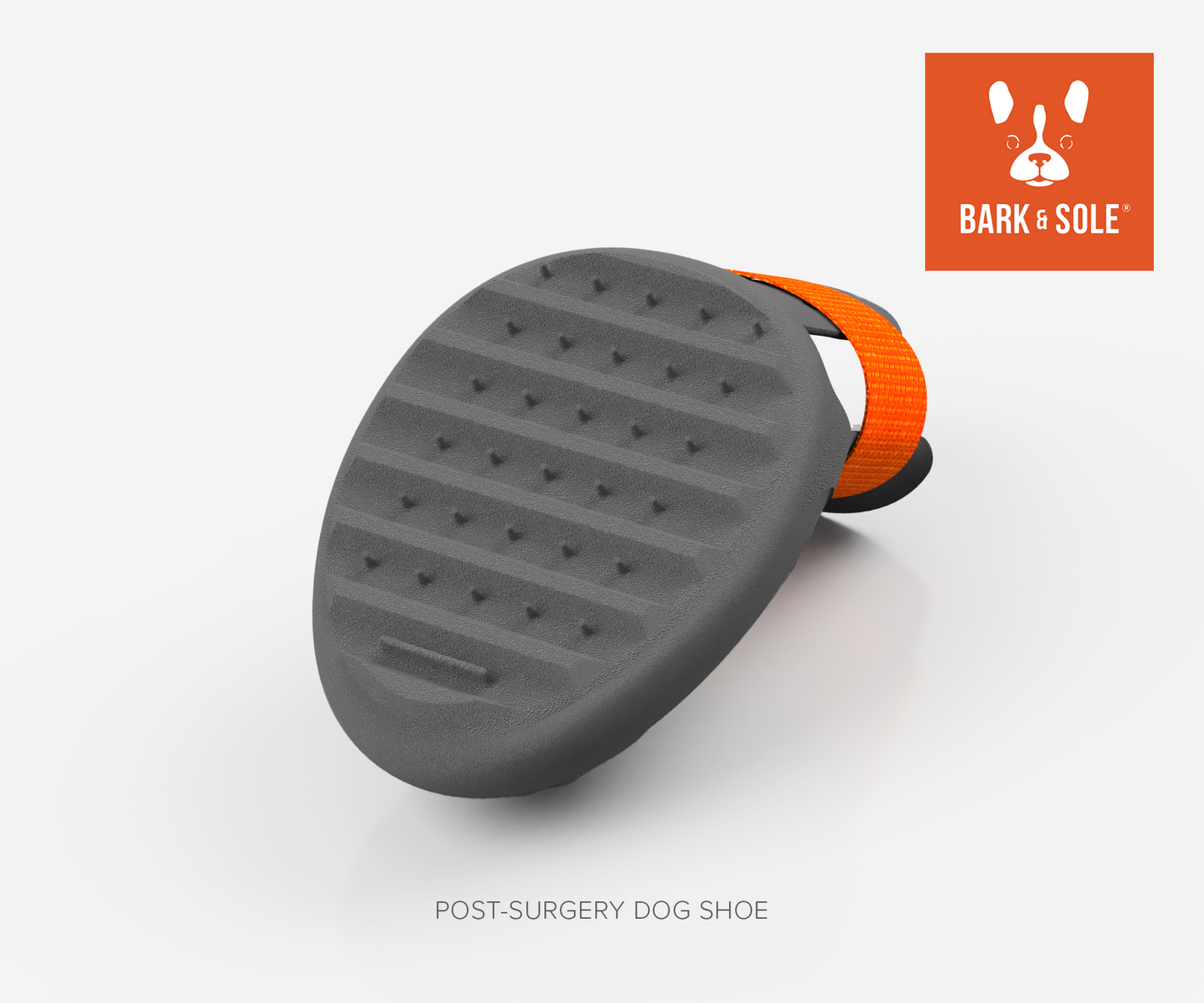 Gray post-surgery dog shoe with orange band on a white background, featuring the Bark & Sole logo.