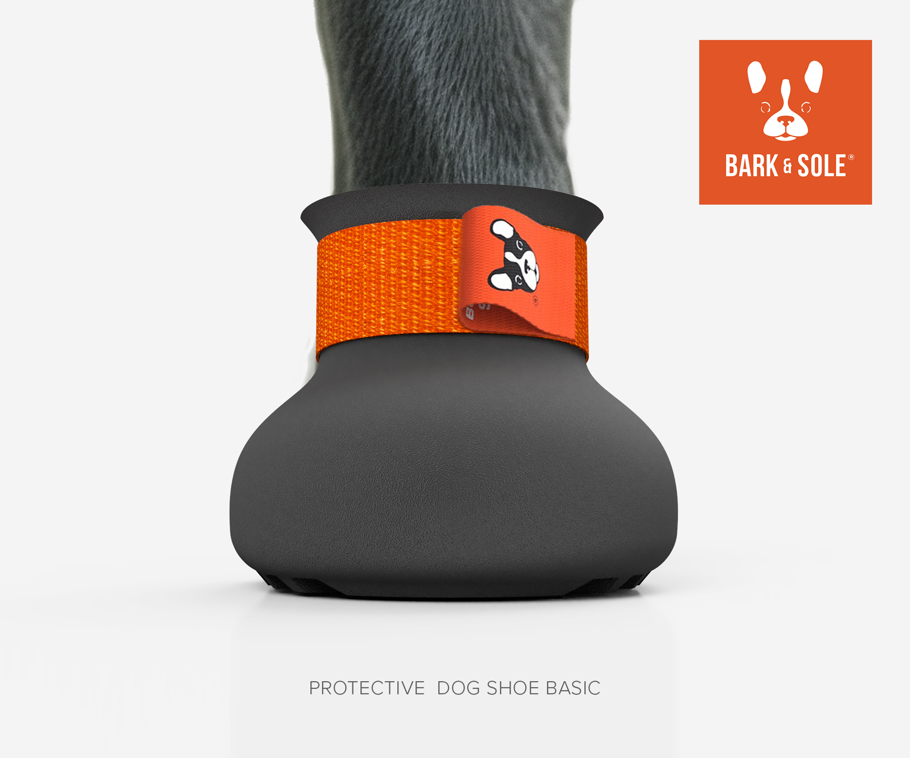 Protective dog shoe with orange strap and 'Bark & Sole' logo on a white background